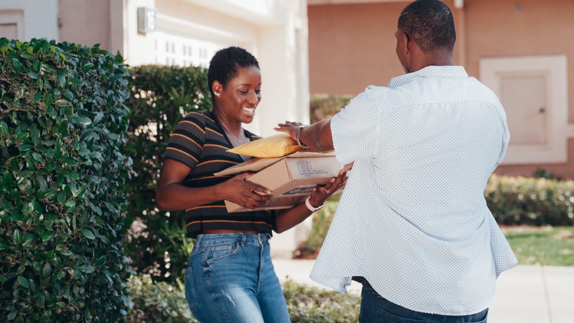 Courier handing a parcel to a customer at their door